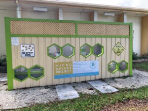 The LBTS apiary is positioned against the back of the Public Works building. Green trim highlights window panes for passers-by to view the bees hard at work.
